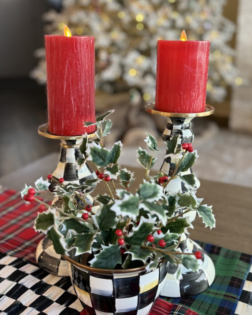 luminara flameless holiday pillars in red with some holly styled as a christmas photo